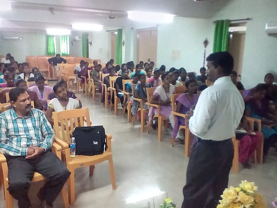 Speaker addressing a seated audience during a seminar