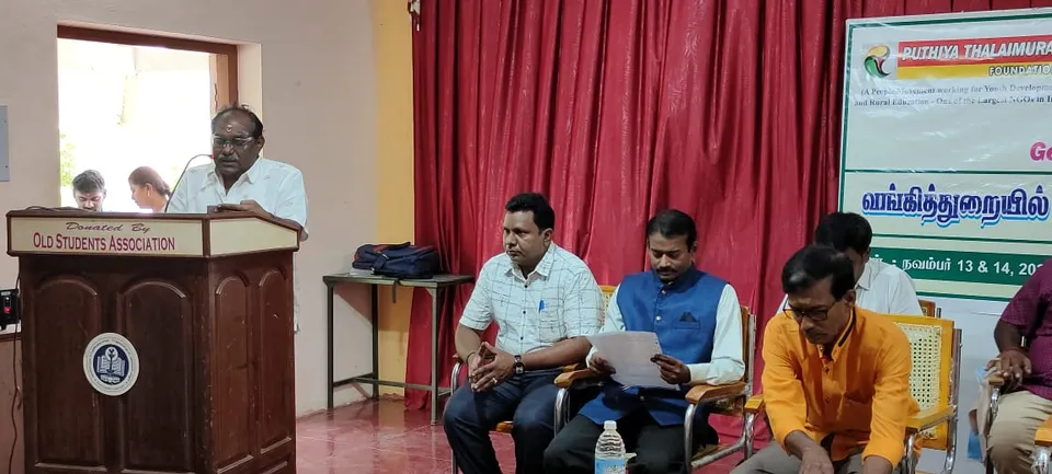 Panelists seated together on an event stage