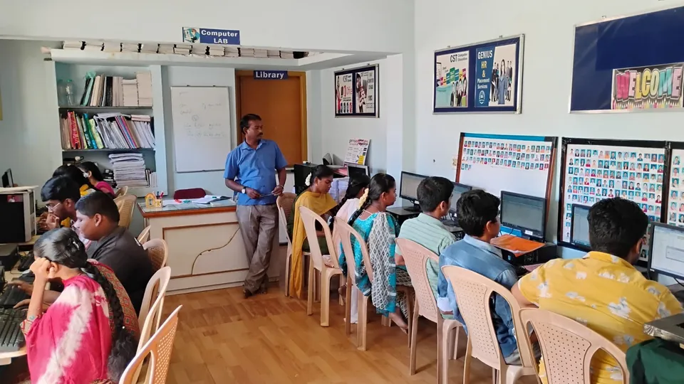 Learners seated at desktop computers in a computer lab
