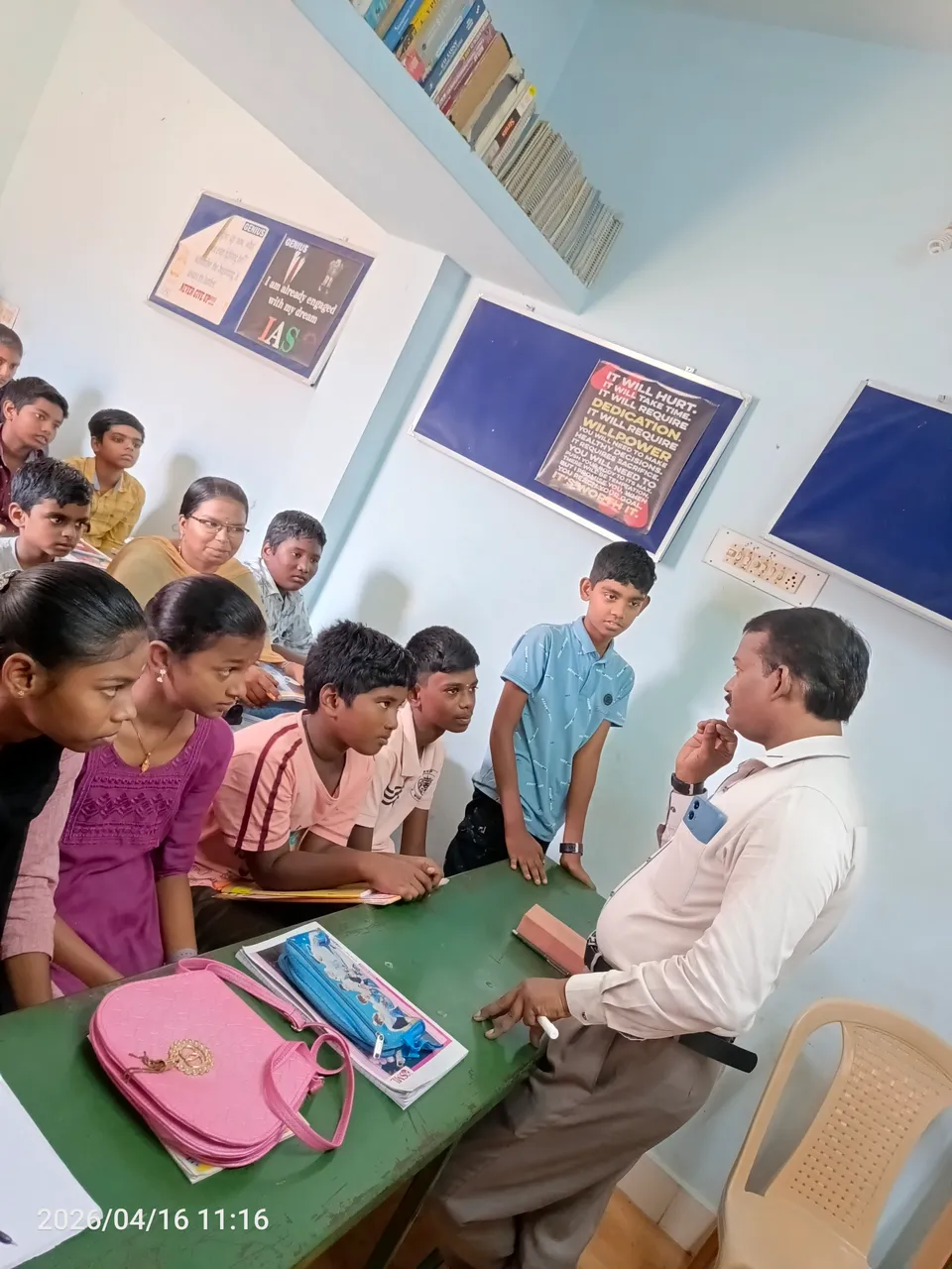 Trainer guiding students gathered around a classroom table