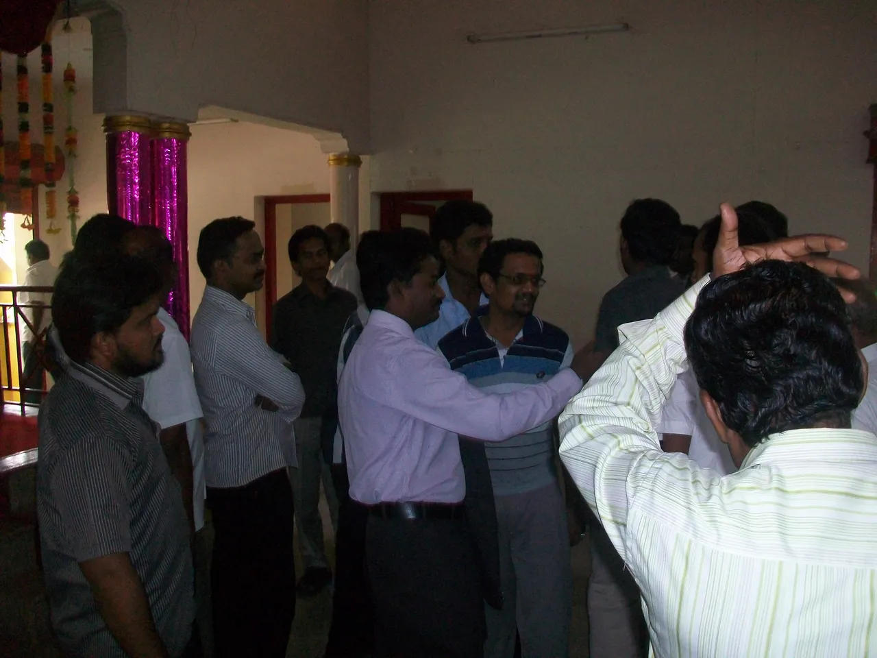 School students raising their hands while a speaker addresses them