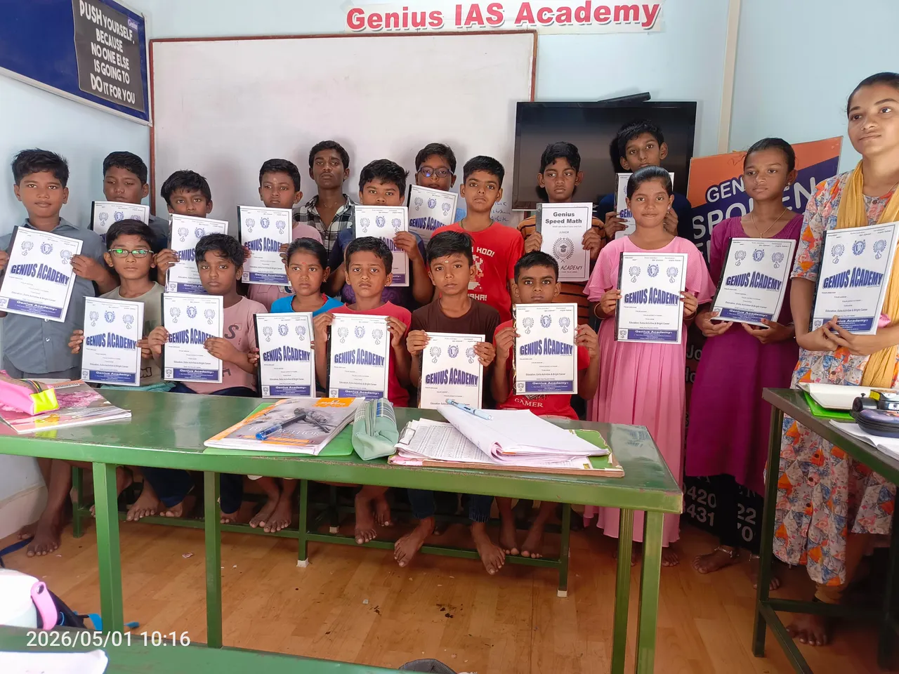 Students standing together holding Genius Academy certificates